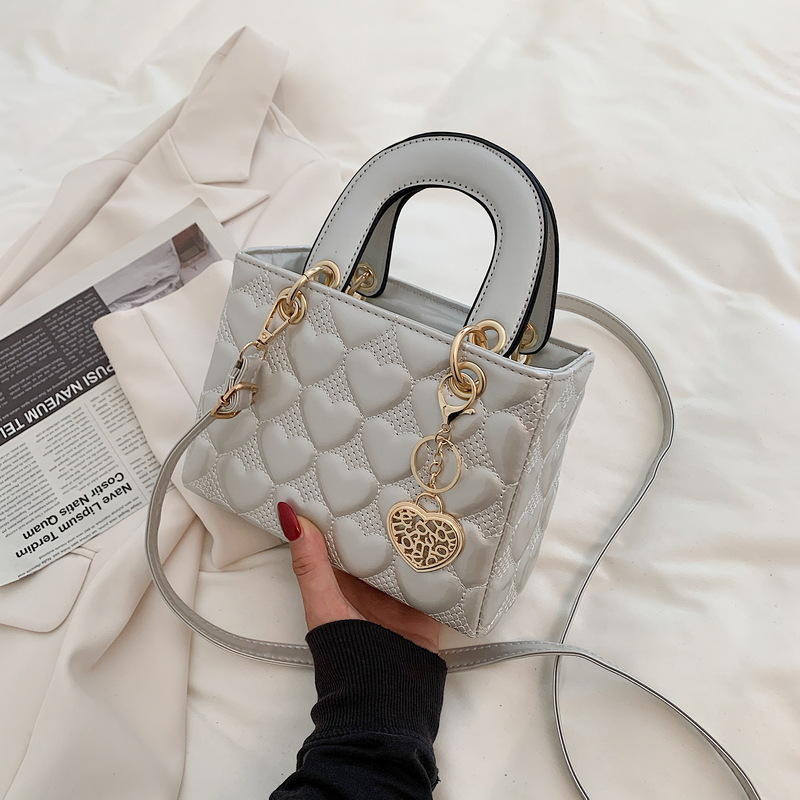 Designer bag Free shipping Lacquer leather heart patterned mini bag with heart-shaped decoration details vintage versatile crossbody bag