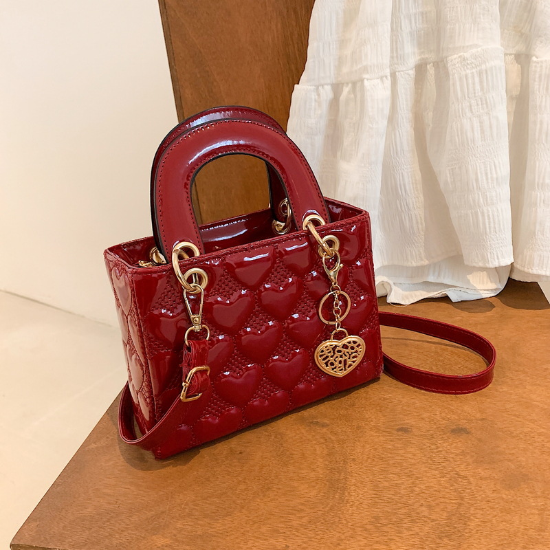 Designer bag Free shipping Lacquer leather heart patterned mini bag with heart-shaped decoration details vintage versatile crossbody bag