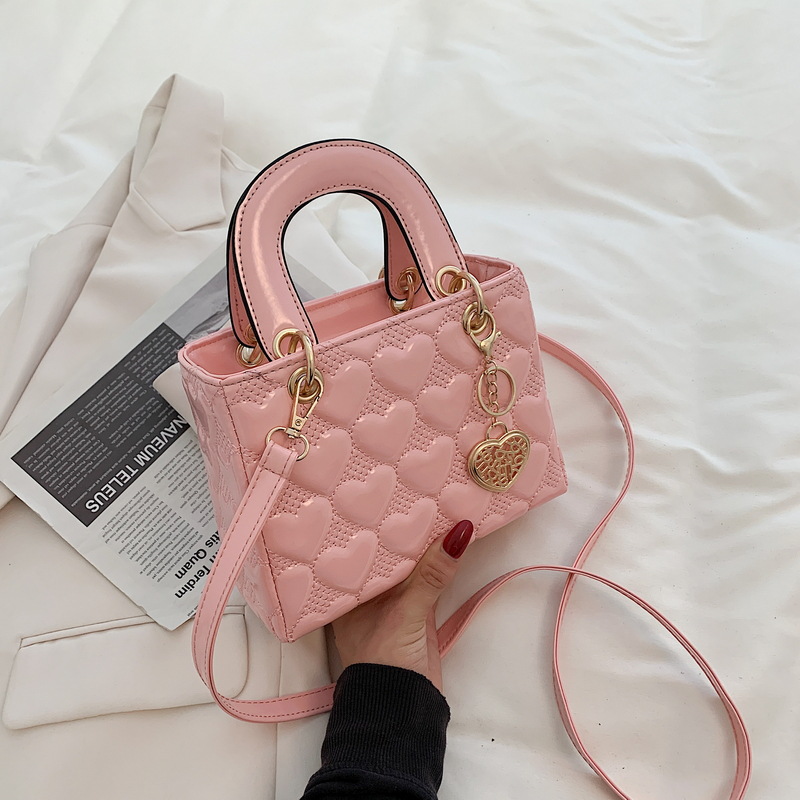 Designer bag Free shipping Lacquer leather heart patterned mini bag with heart-shaped decoration details vintage versatile crossbody bag