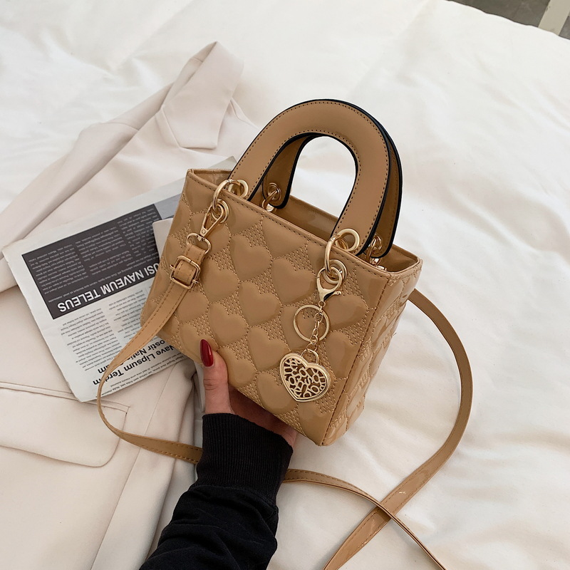 Designer bag Free shipping Lacquer leather heart patterned mini bag with heart-shaped decoration details vintage versatile crossbody bag