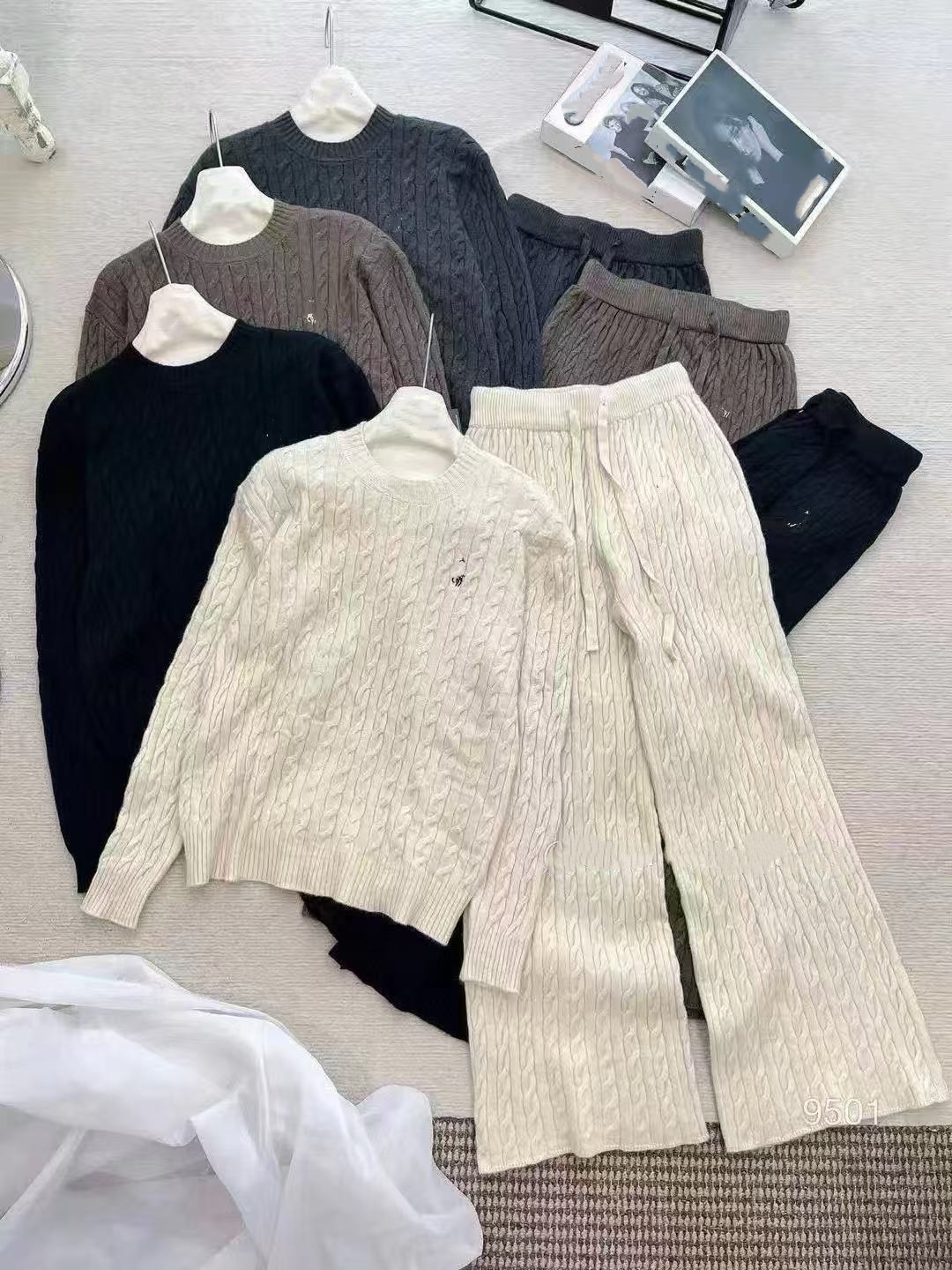 Ladies fashion set embroidered cable-knit long-sleeved sweater and high-waisted trousers.