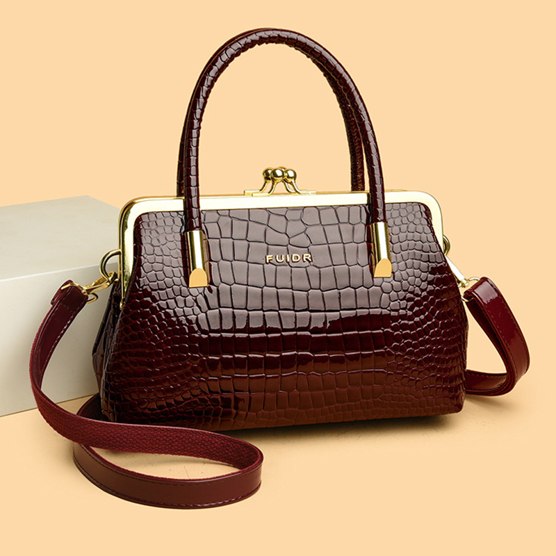 Manufacturer's spot wholesale women's handbags, fashionable diagonal cross clip mouth bags, European and American Spanish women's bags,