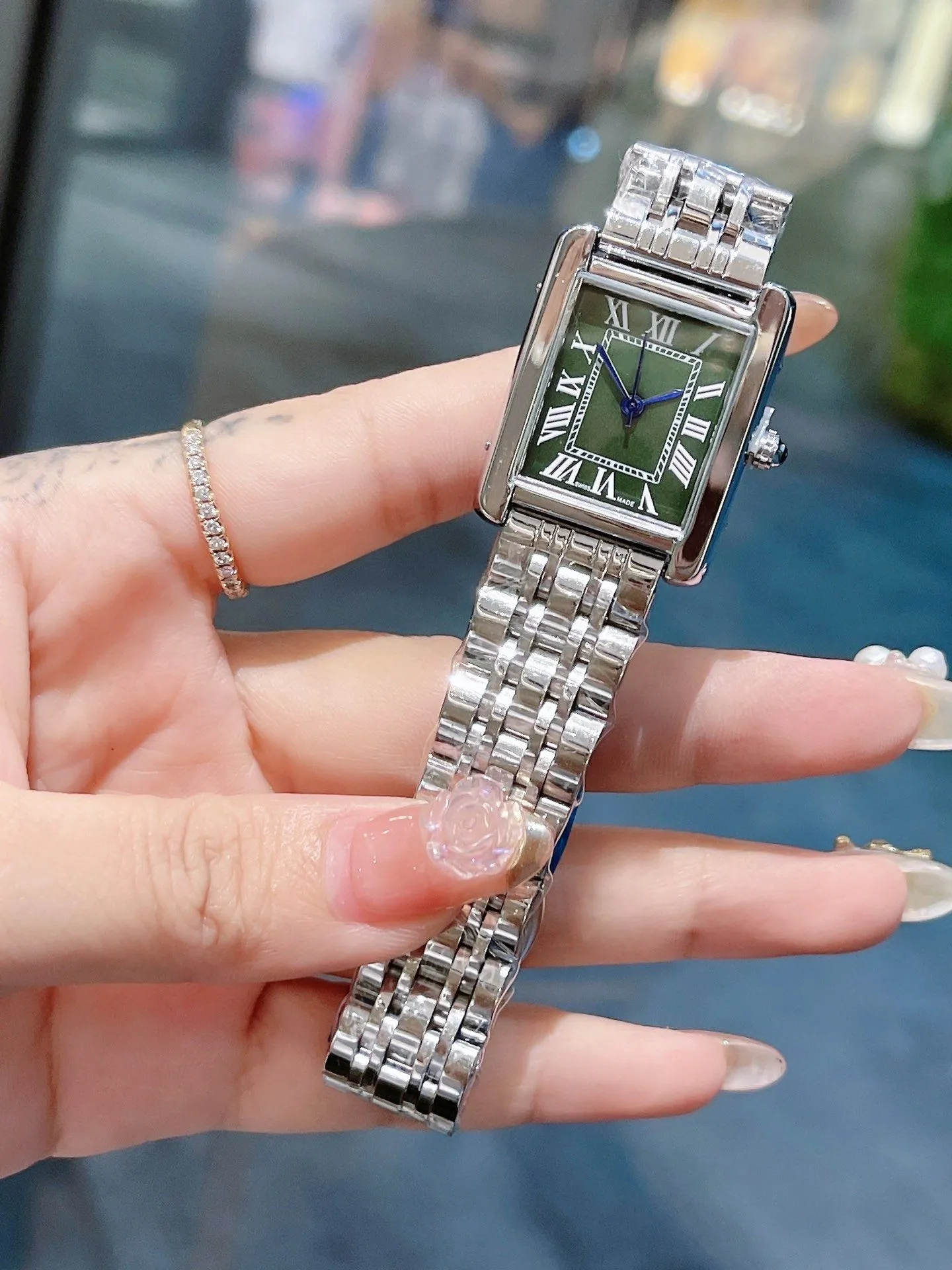 Women's designer model featuring diamond material, high-quality quartz movement, stainless steel strap, and water-resistant function