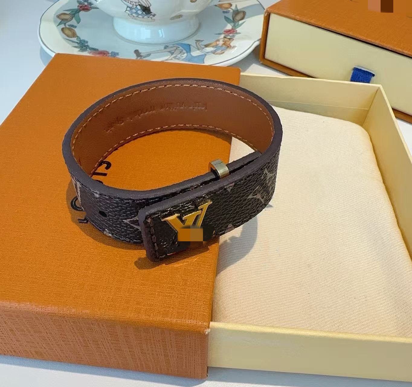 Bracelets designer Premium Leather Bracelet with Metal Logo Buckle - Trendy Monogram Pattern Wrist Cuff Adjustable Fit Fashion Accessory for Holiday Gift very good