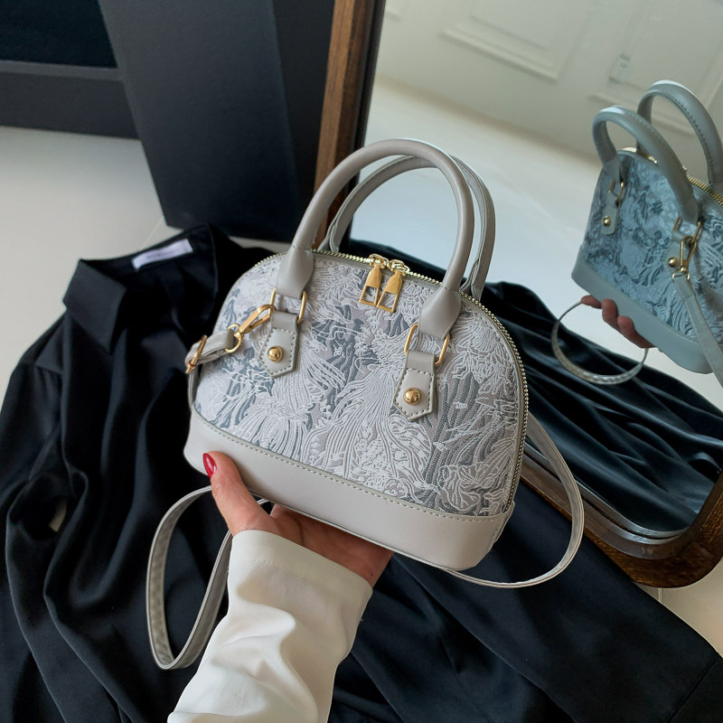 Crossbody casual commuting handheld shell bag womens 2026 spring new style simple and fashionable single shoulder