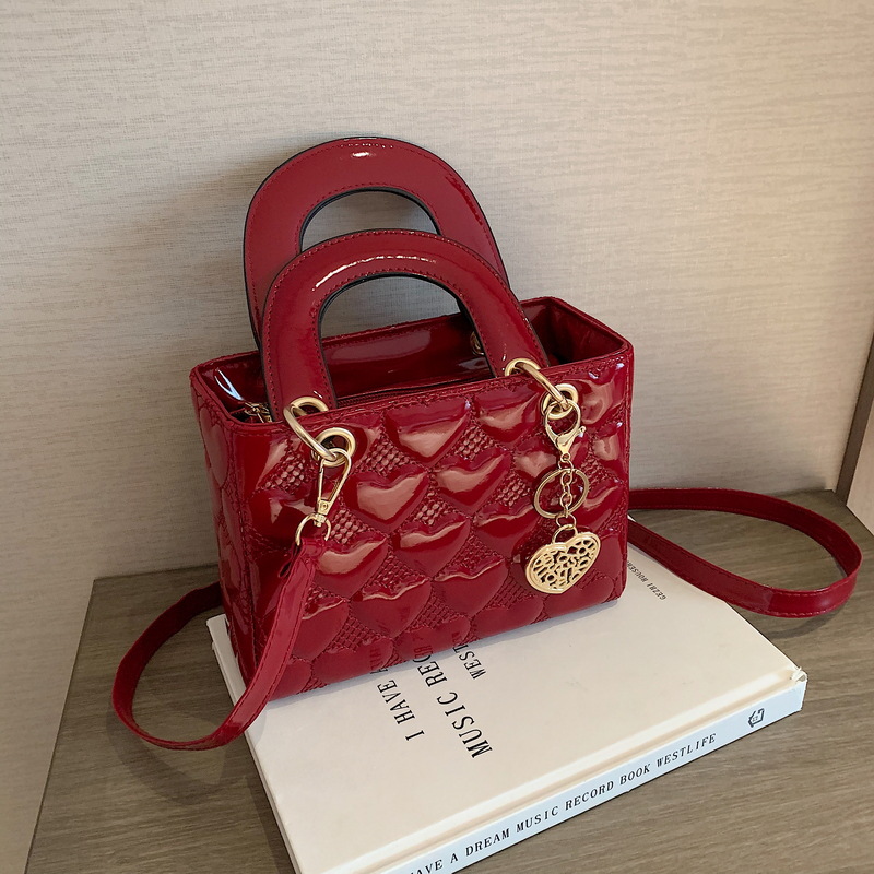 Free shipping bag Lacquer leather heart patterned mini bag with heart-shaped decoration details vintage versatile crossbody bag