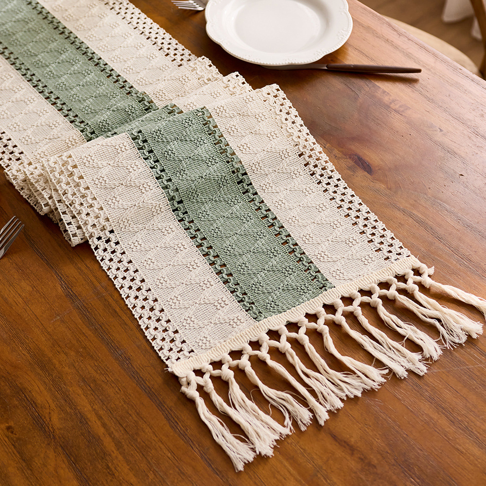 Sage green cotton table runner with tassels and openwork design, perfect for kitchen or dining table decoration. EQ2M01