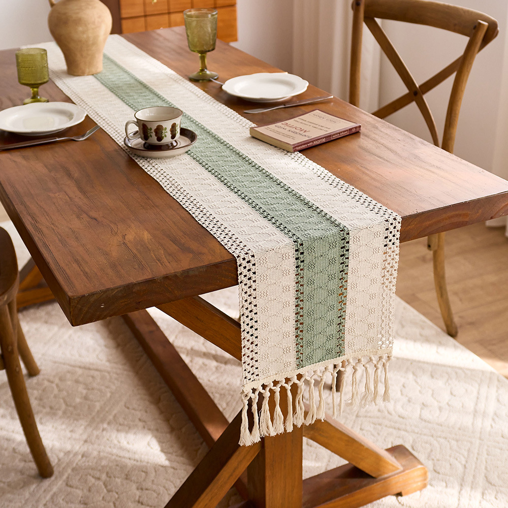 Sage green cotton table runner with tassels and openwork design, perfect for kitchen or dining table decoration. EQ2M01