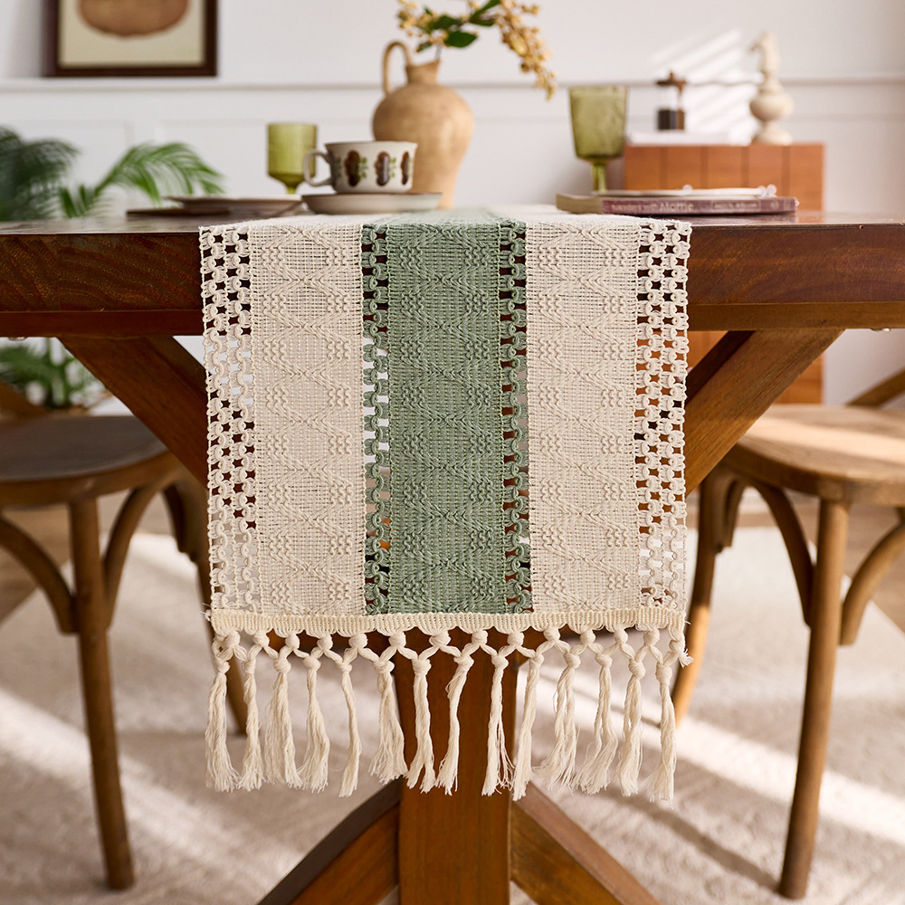 Sage green cotton table runner with tassels and openwork design, perfect for kitchen or dining table decoration. EQ2M01