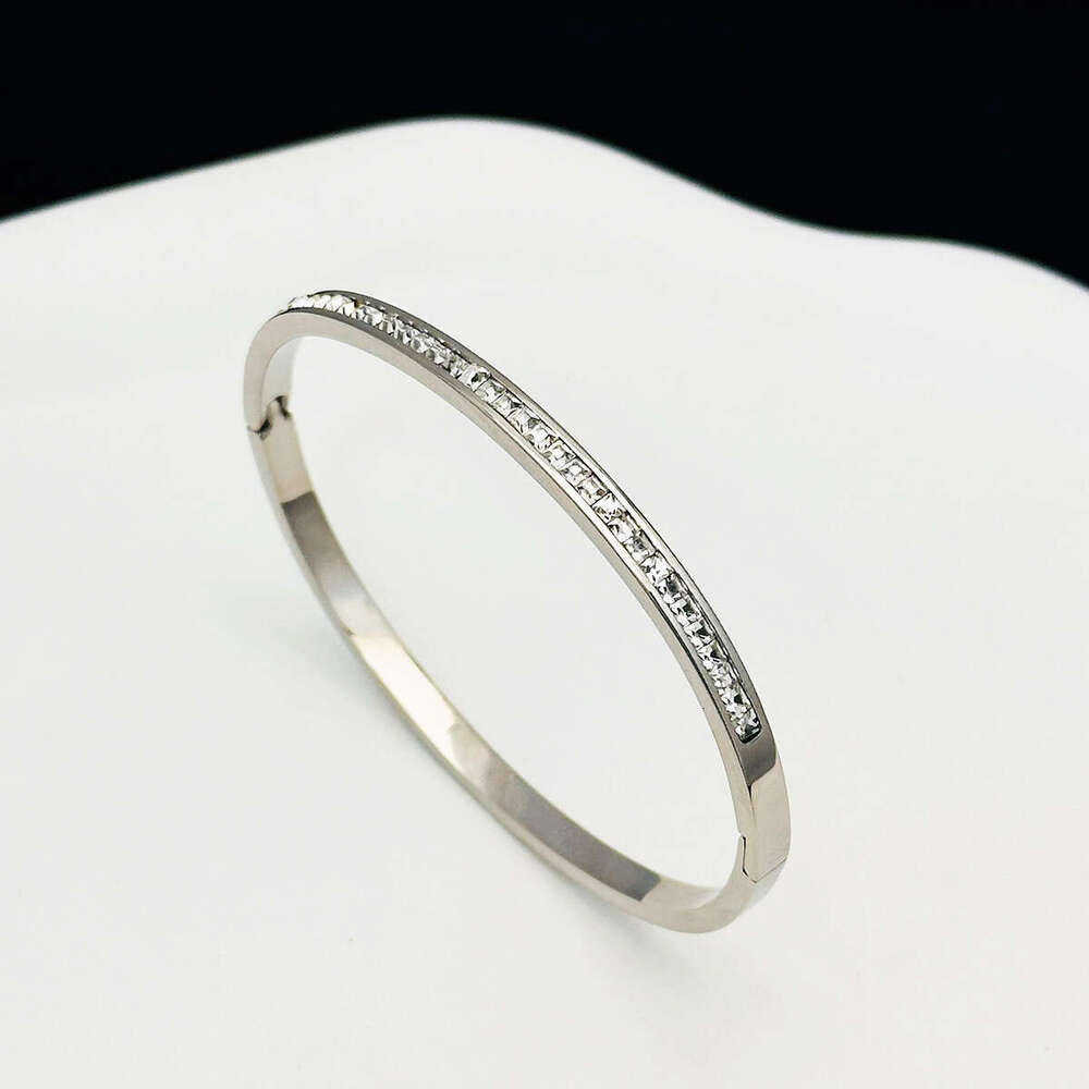 DHCollections Elegant Crystal Bangle Bracelet Stainless Steel Luxe Star inspired Stackable Cuff for Women