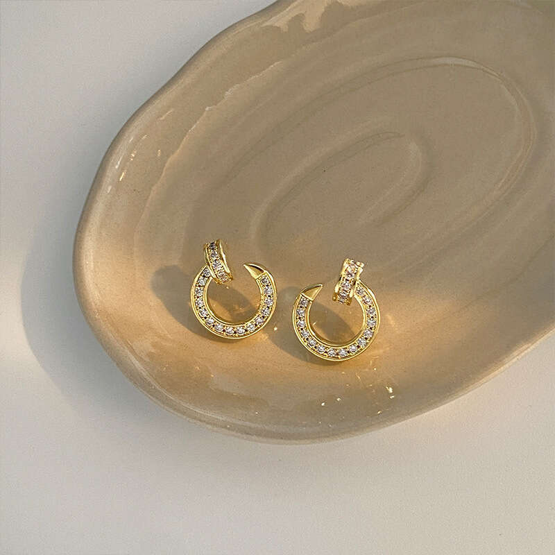 DHCollections Stylish Hoop Earrings Dazzling Metal Round Shape Statement Jewelry For Women