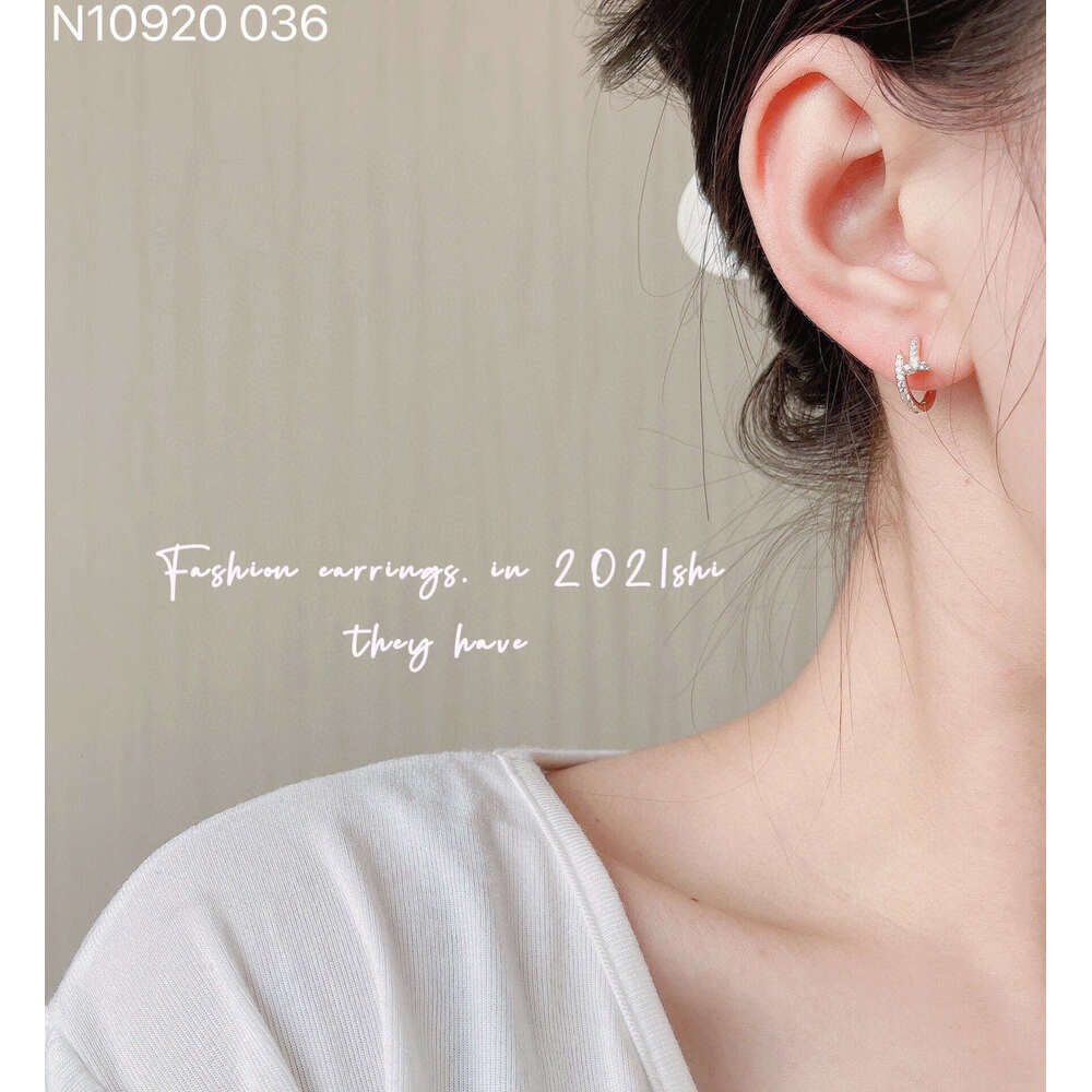 DHCollections Elegant Minimalist Hoop Earrings Modern Chic Dangle Style For Women In Gold And Silver Options