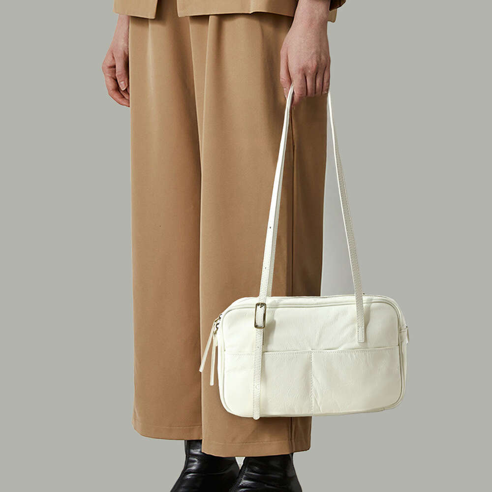 Luxury designer new ladies personality fashion authentic portable waxed leather commuting armpit Korean style large-capacity shoulder bag.