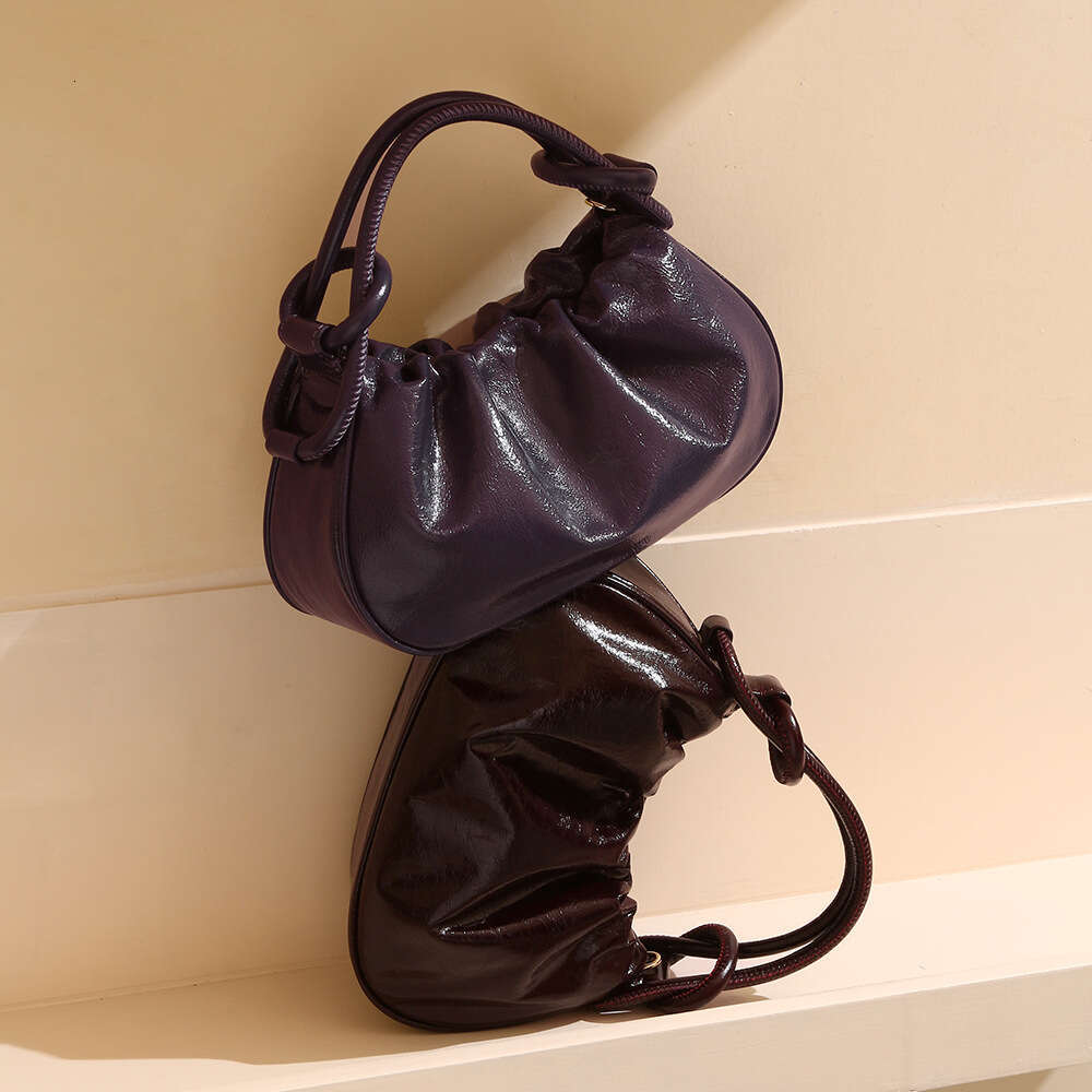 Luxury designer Crystal Wax cowhide portable autumn and winter high-end hand slung commuter Joker jiaozi handbag.