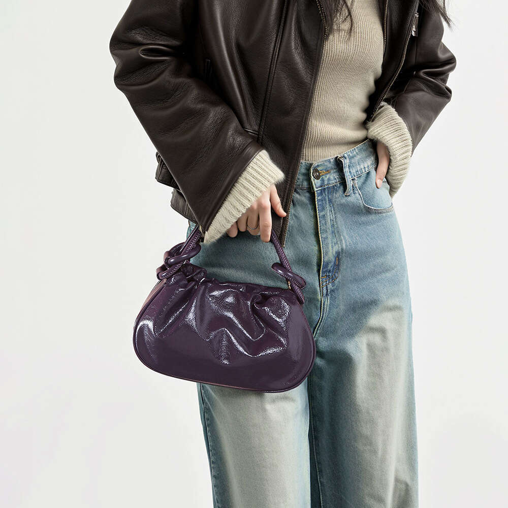 Luxury designer Crystal Wax cowhide portable autumn and winter high-end hand slung commuter Joker jiaozi handbag.