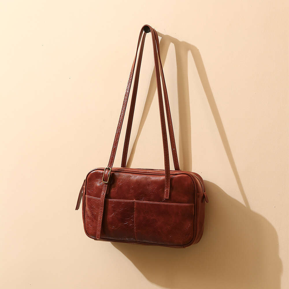 Luxury designer new ladies personality fashion authentic portable waxed leather commuting armpit Korean style large-capacity shoulder bag.