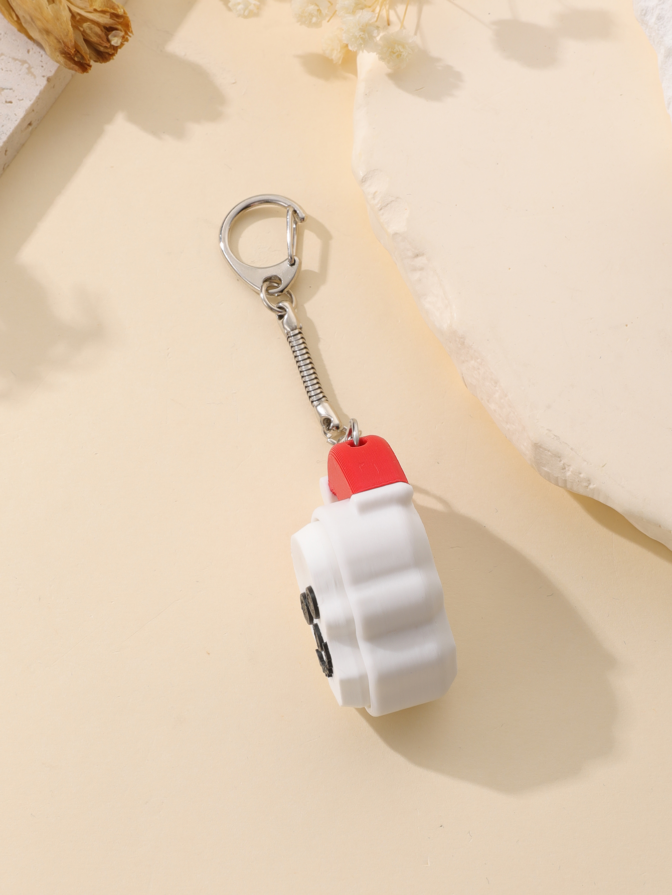 3D printed Christmas hat skull keychain - adult stress relief toy, with a portable anxiety relief gadget featuring a clickable keyboard design