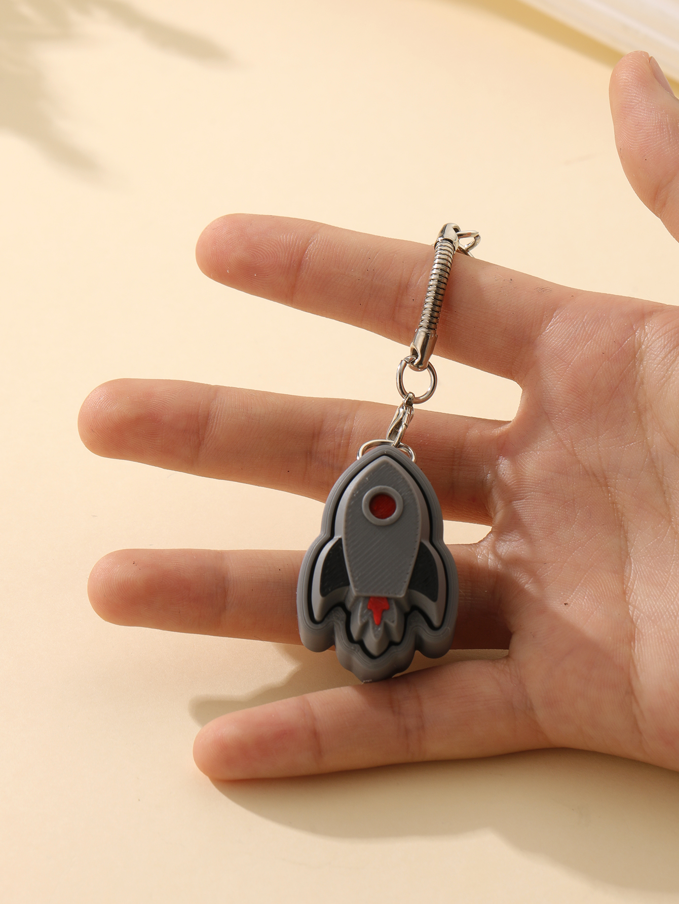 3D printed rocket keychain - an adult stress relief toy with a portable anxiety-reducing gadget featuring a clickable keyboard design