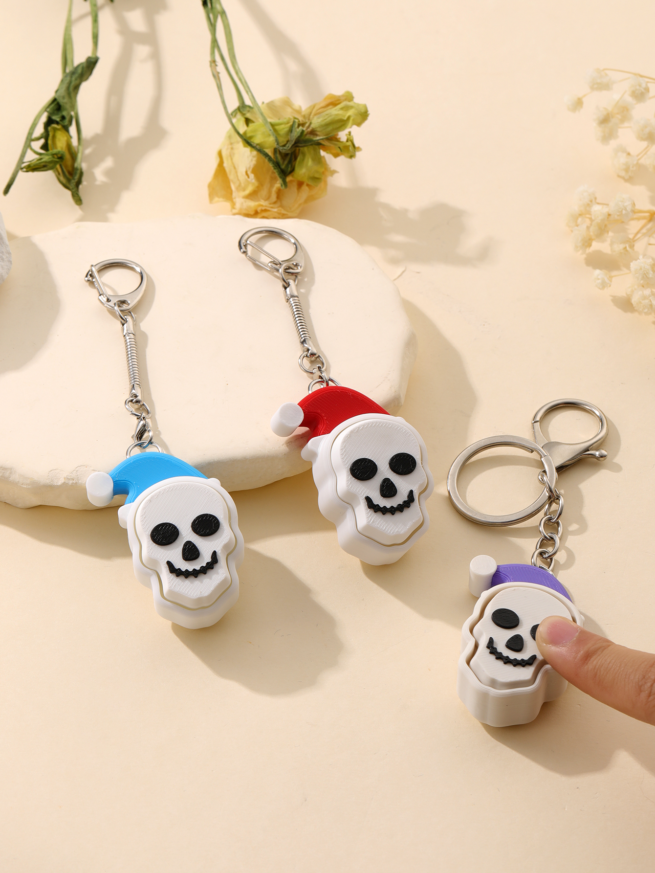 3D printed Christmas hat skull keychain - adult stress relief toy, with a portable anxiety relief gadget featuring a clickable keyboard design
