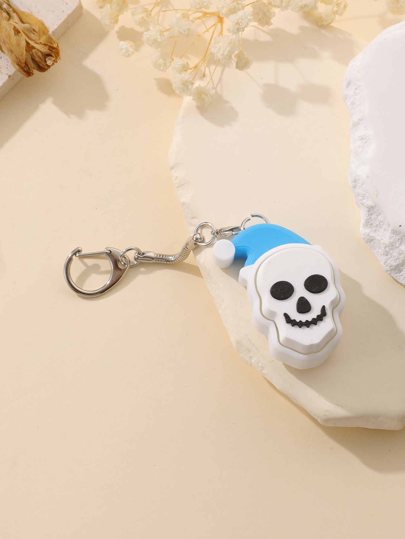 3D printed Christmas hat skull keychain - adult stress relief toy, with a portable anxiety relief gadget featuring a clickable keyboard design