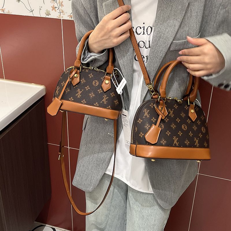 Light luxury Fashionable female Advanced printed retro light luxury hand-held vintage flower shell bag new versatile and temperament crossbody bag sho
