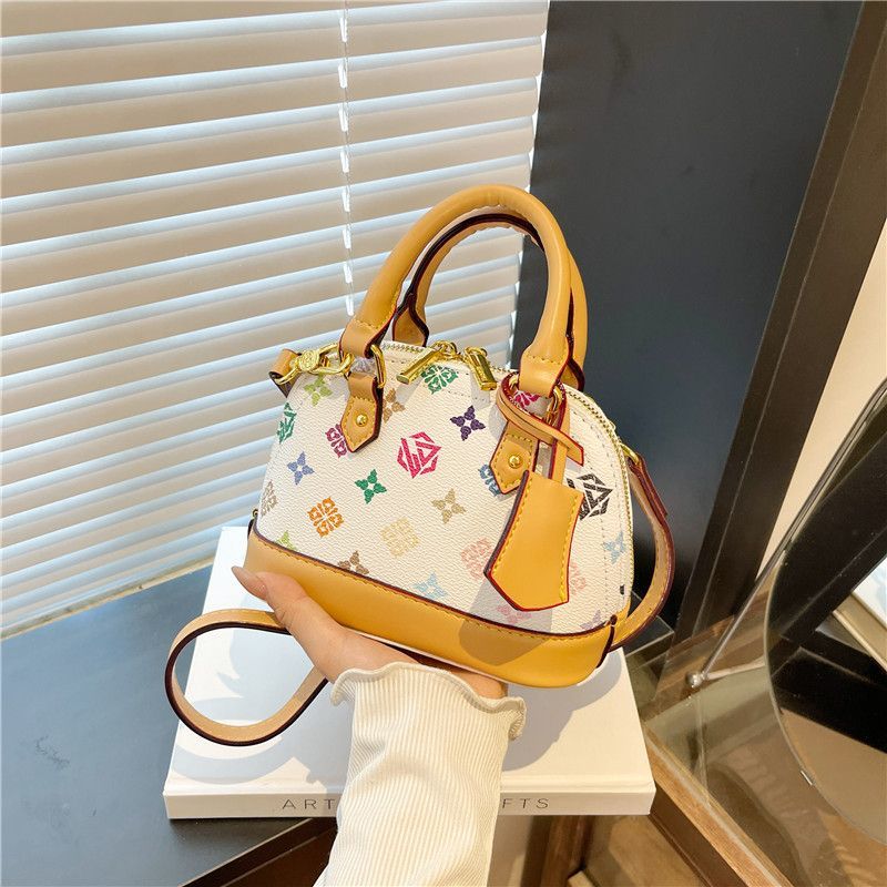 Light luxury Fashionable female Advanced printed retro light luxury hand-held vintage flower shell bag new versatile and temperament crossbody bag sho