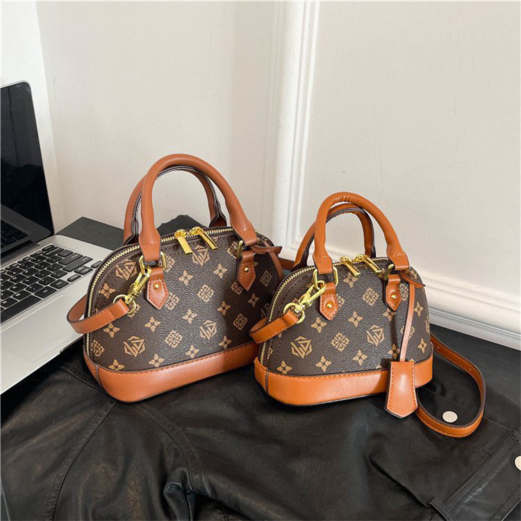 Light luxury Fashionable female Advanced printed retro light luxury hand-held vintage flower shell bag new versatile and temperament crossbody bag sho