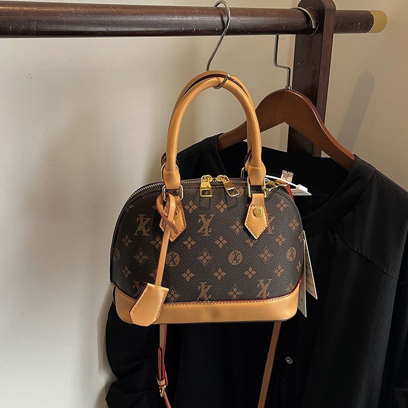 Light luxury Fashionable female Advanced printed retro light luxury hand-held vintage flower shell bag new versatile and temperament crossbody bag sho