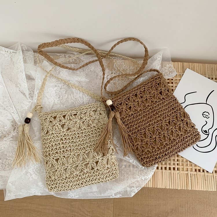 2025 Summer new women's shoulder crossbody bag tassel phone bag hollowed out tassel handmade woven bag grass bag beach shoulder bag new designer 