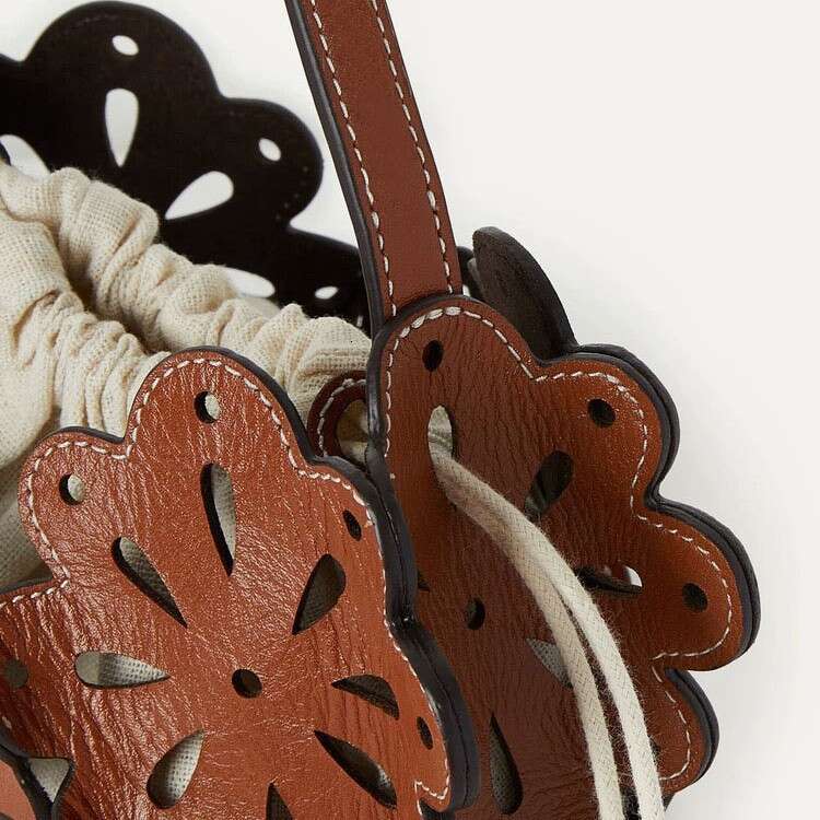 chic mixed media patchwork purse featuring delicate blossoms sleek practical unisex backpack