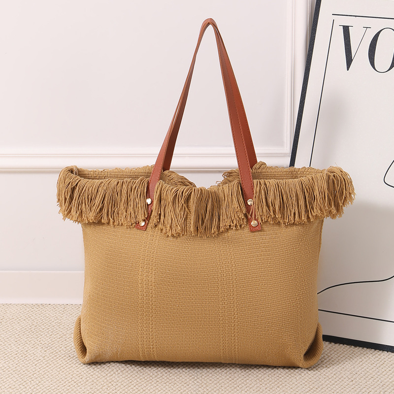 Summer new women's shoulder bag, new tassel handbag, large capacity simple handheld shoulder canvas bag, commuting woven beach bag, new women