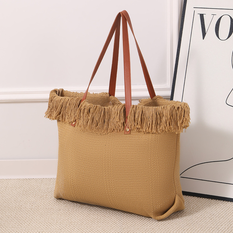 Summer new women's shoulder bag, new tassel handbag, large capacity simple handheld shoulder canvas bag, commuting woven beach bag, new women