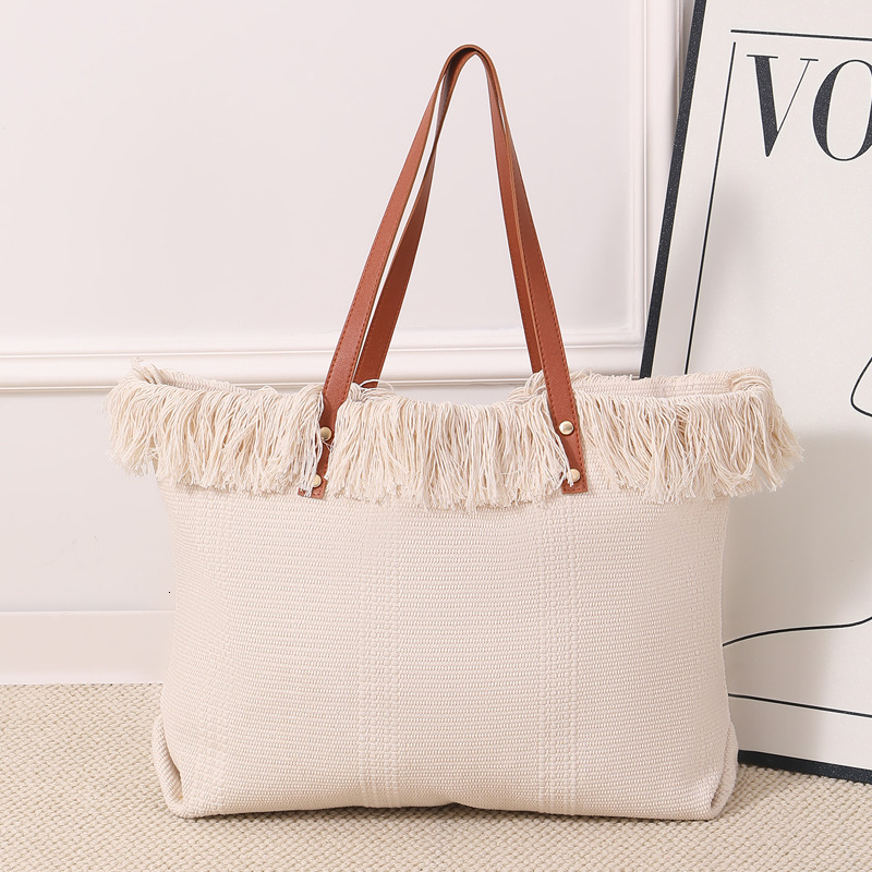 Summer new women's shoulder bag, new tassel handbag, large capacity simple handheld shoulder canvas bag, commuting woven beach bag, new women