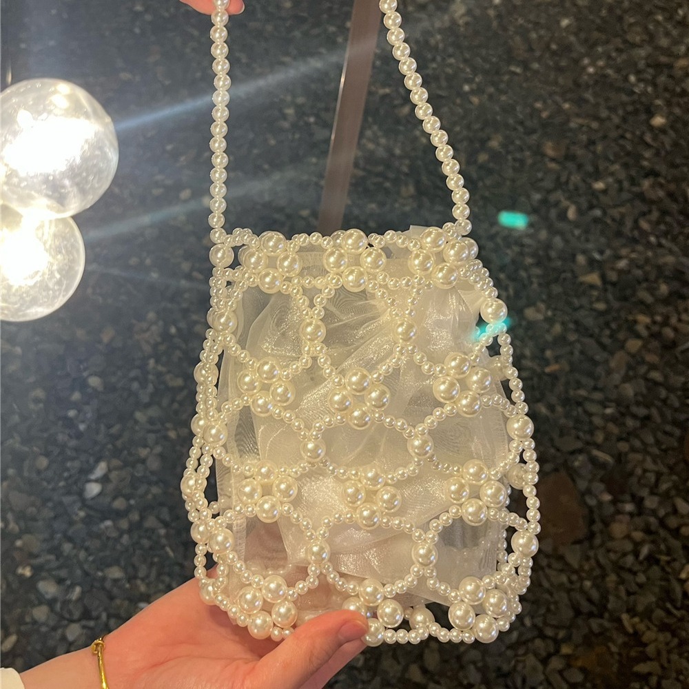 2025 Summer new women's shoulder bag new fashion niche solid women's color handmade retro small round bead hollow weave women's handbag