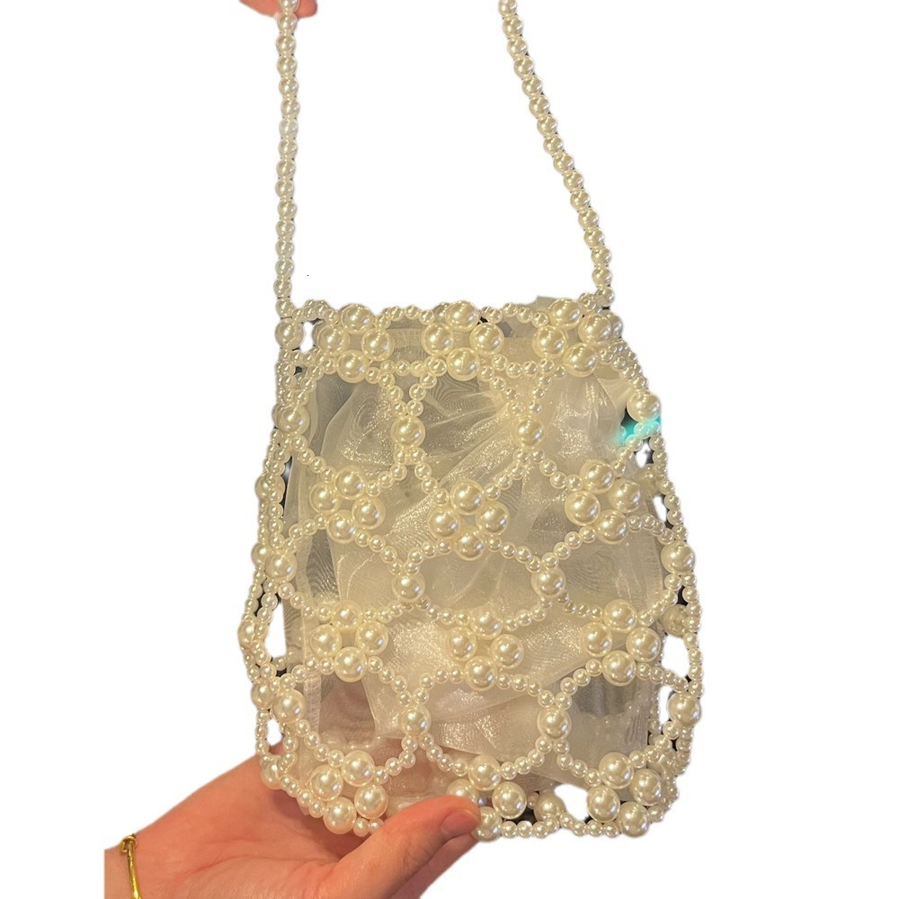 2025 Summer new women's shoulder bag new fashion niche solid women's color handmade retro small round bead hollow weave women's handbag