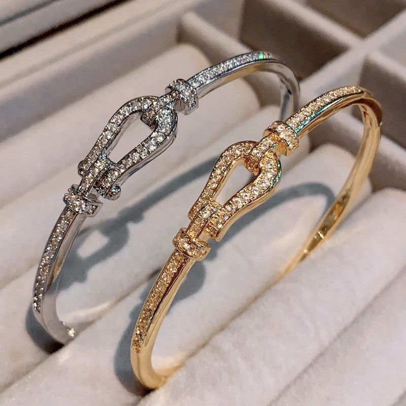 Gold Tone Twisted Buckle Bangle Bracelet Crystal Accents Elegant Party Jewelry And Gift For Her High Quality Stylish Design