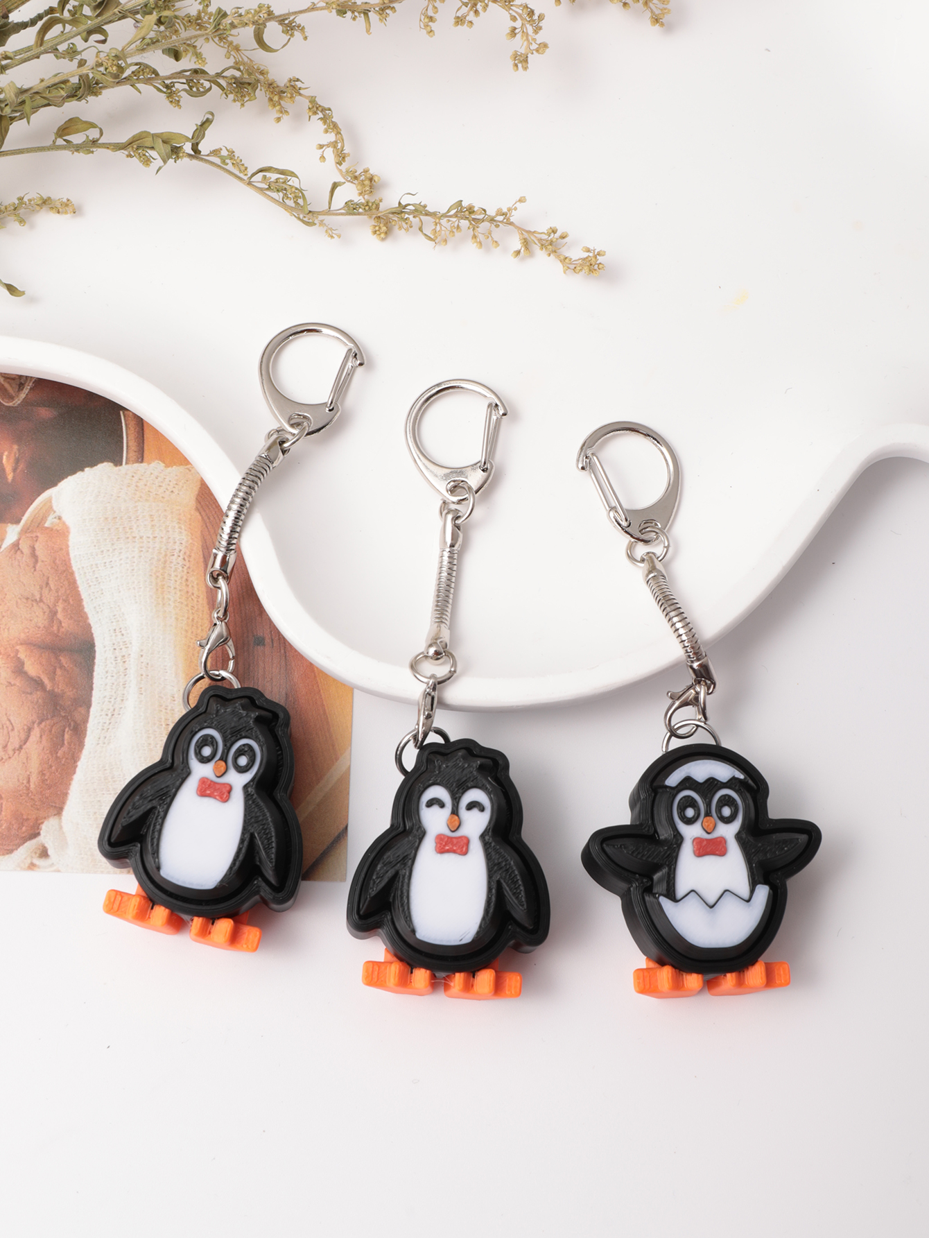 3D printed penguin keychain - an adult stress relief toy with a portable anxiety-reducing gadget featuring a clickable keyboard design