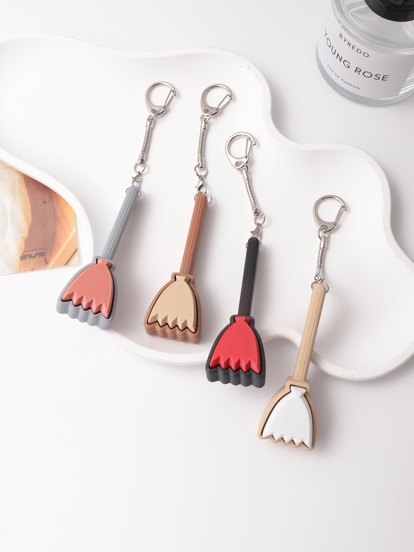 3D printed broom-shaped keychain - an adult stress relief toy with a portable anxiety relief gadget featuring a clickable keyboard design