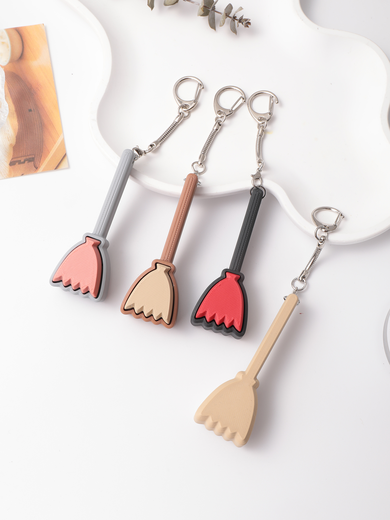 3D printed broom-shaped keychain - an adult stress relief toy with a portable anxiety relief gadget featuring a clickable keyboard design