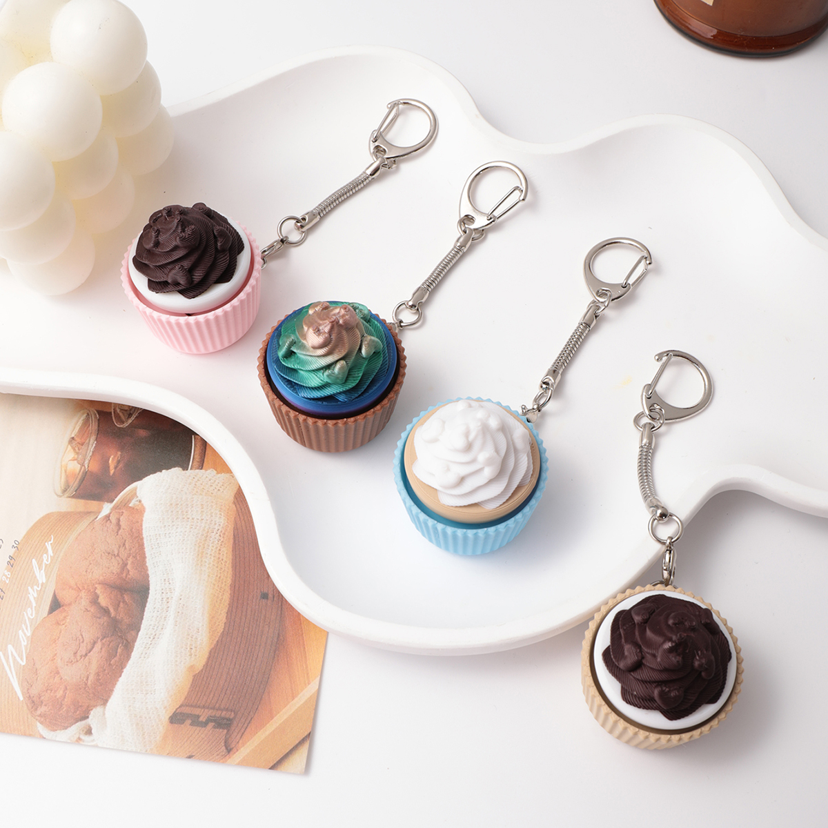 3D printed cupcake-shaped keychain - an adult stress relief toy with a portable anxiety-reducing gadget featuring a clickable keyboard design