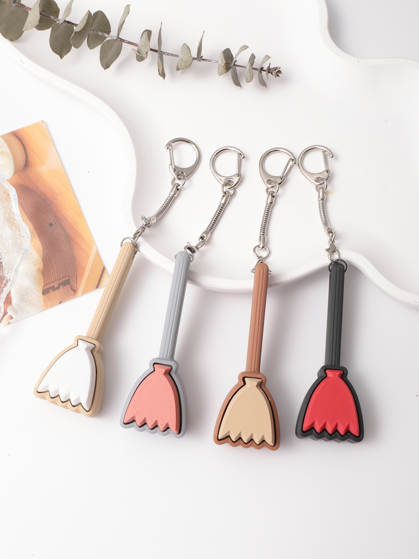 3D printed broom-shaped keychain - an adult stress relief toy with a portable anxiety relief gadget featuring a clickable keyboard design