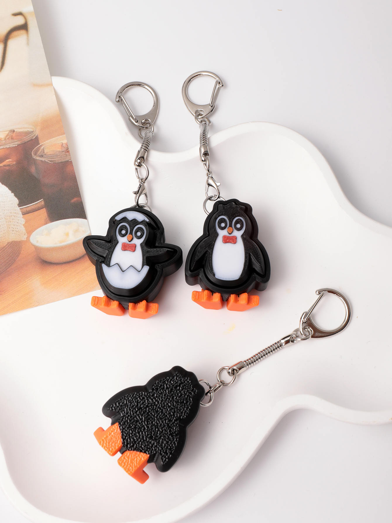 3D printed penguin keychain - an adult stress relief toy with a portable anxiety-reducing gadget featuring a clickable keyboard design