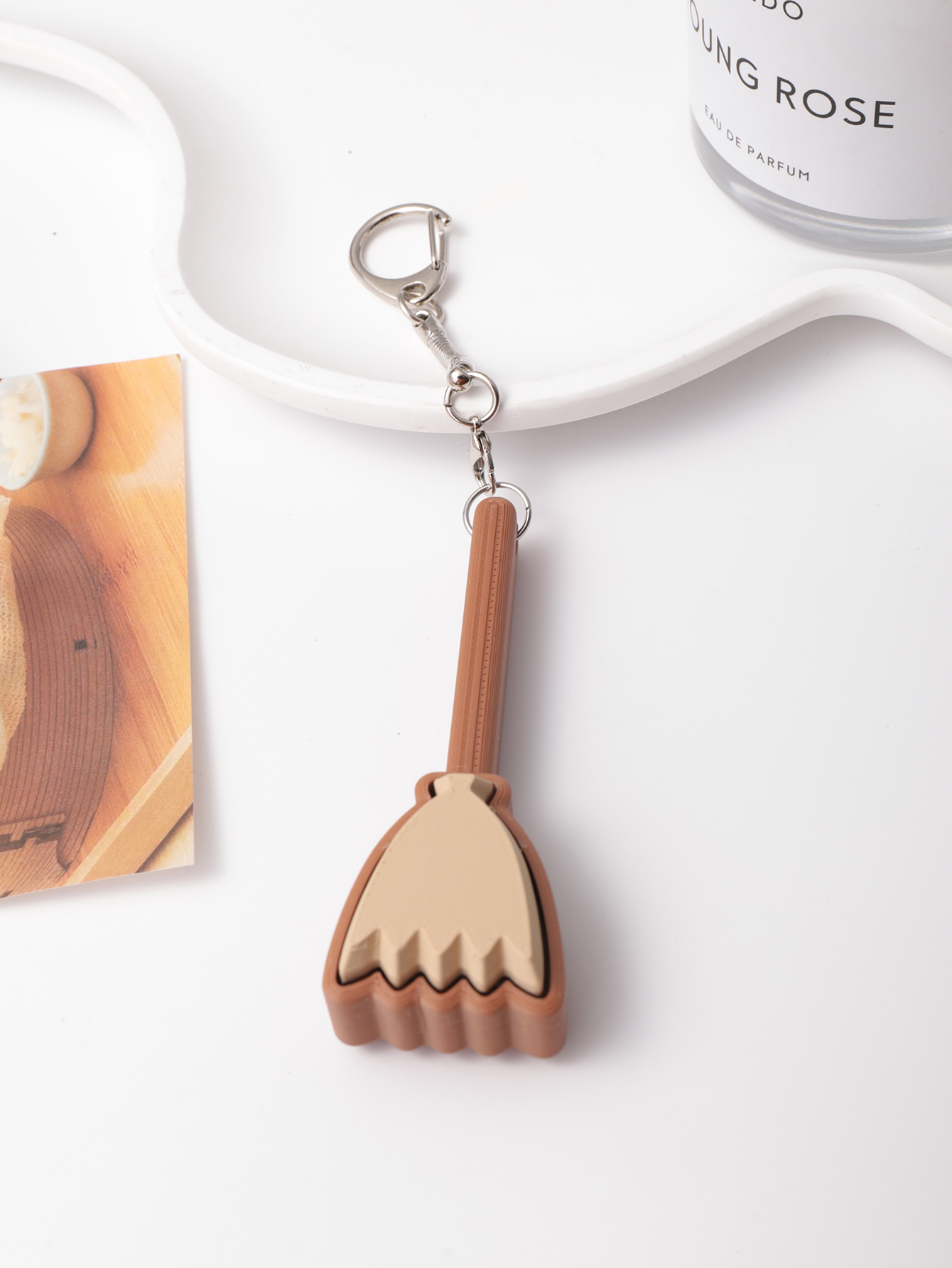 3D printed broom-shaped keychain - an adult stress relief toy with a portable anxiety relief gadget featuring a clickable keyboard design