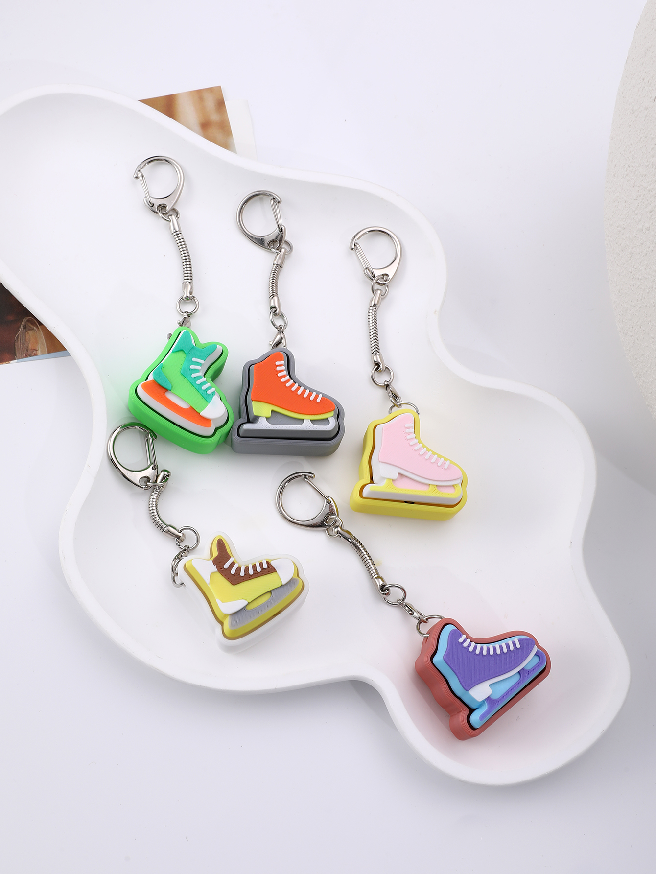 3D printed skating shoe-shaped keychain - an adult stress relief toy with a portable anxiety-reducing gadget featuring a clickable keyboard design