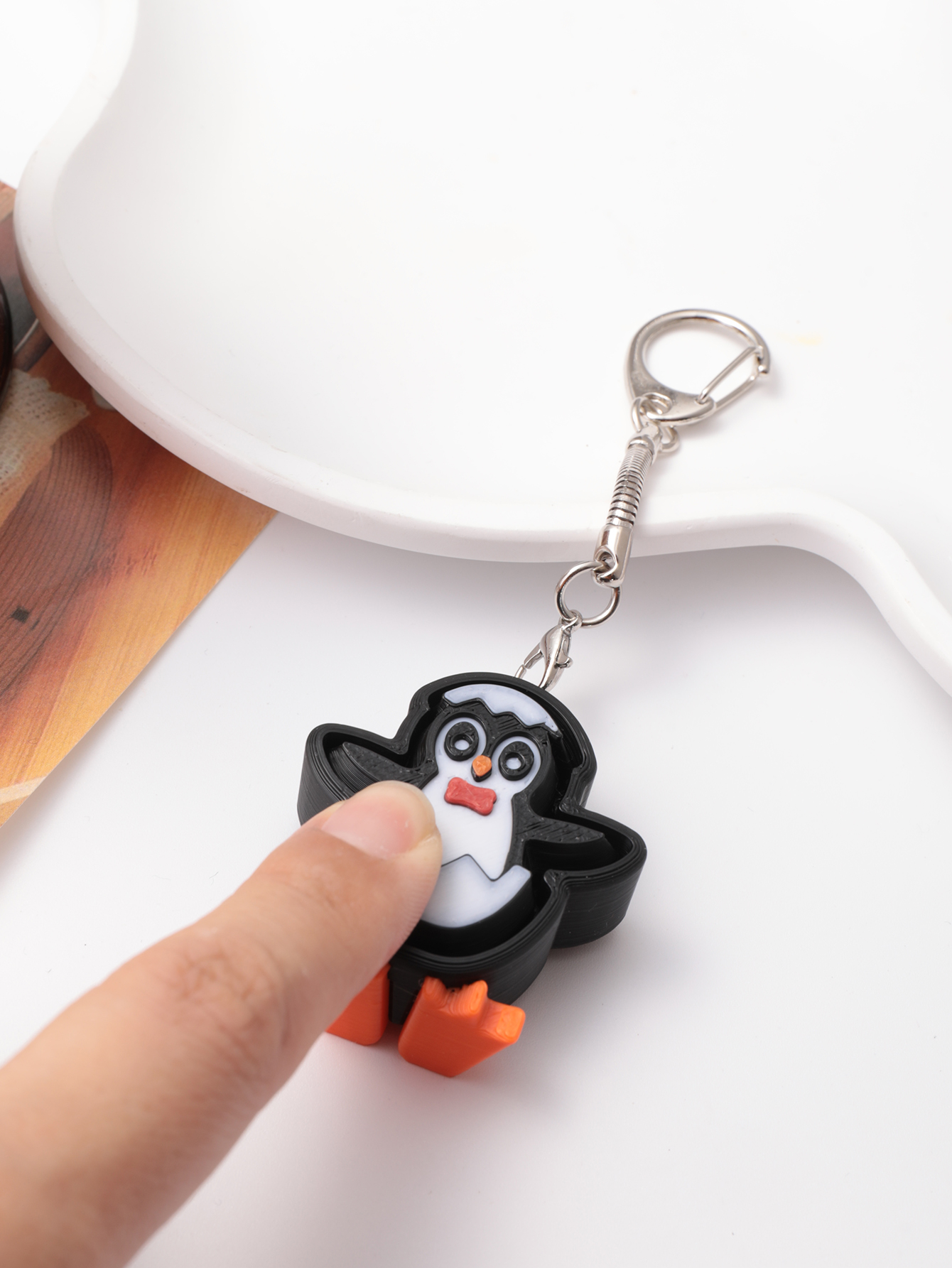 3D printed penguin keychain - an adult stress relief toy with a portable anxiety-reducing gadget featuring a clickable keyboard design