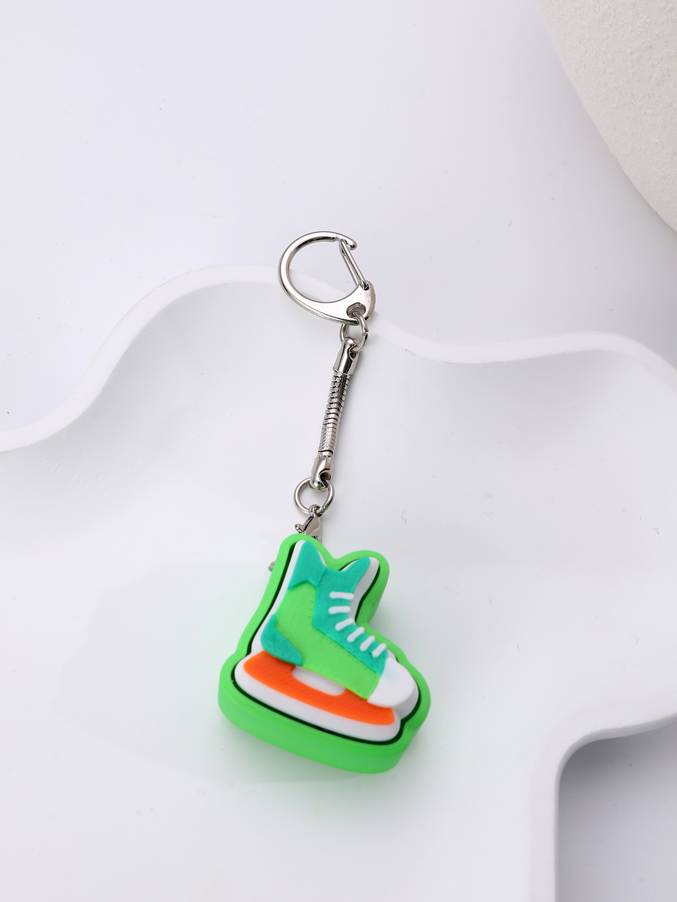 3D printed skating shoe-shaped keychain - an adult stress relief toy with a portable anxiety-reducing gadget featuring a clickable keyboard design