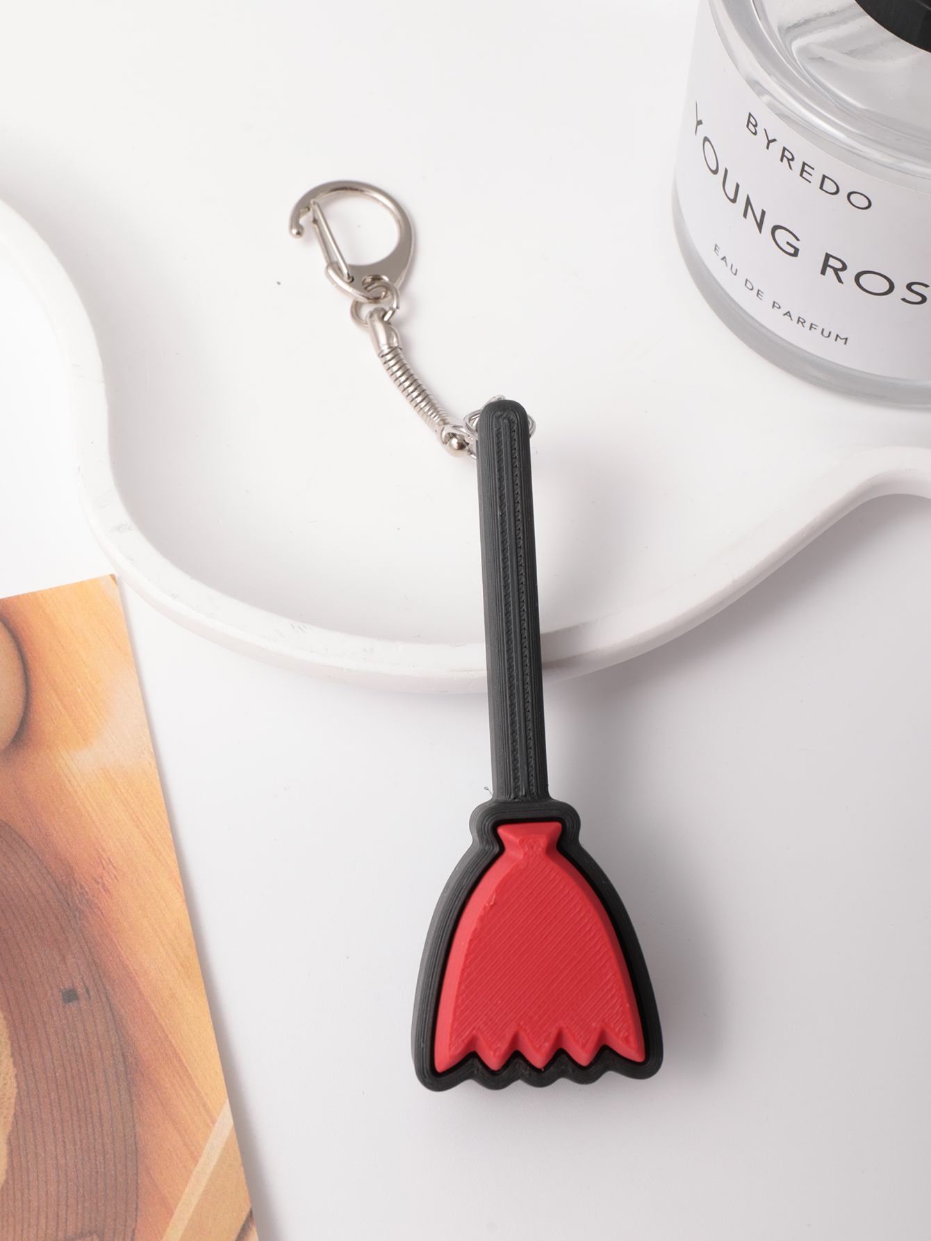 3D printed broom-shaped keychain - an adult stress relief toy with a portable anxiety relief gadget featuring a clickable keyboard design