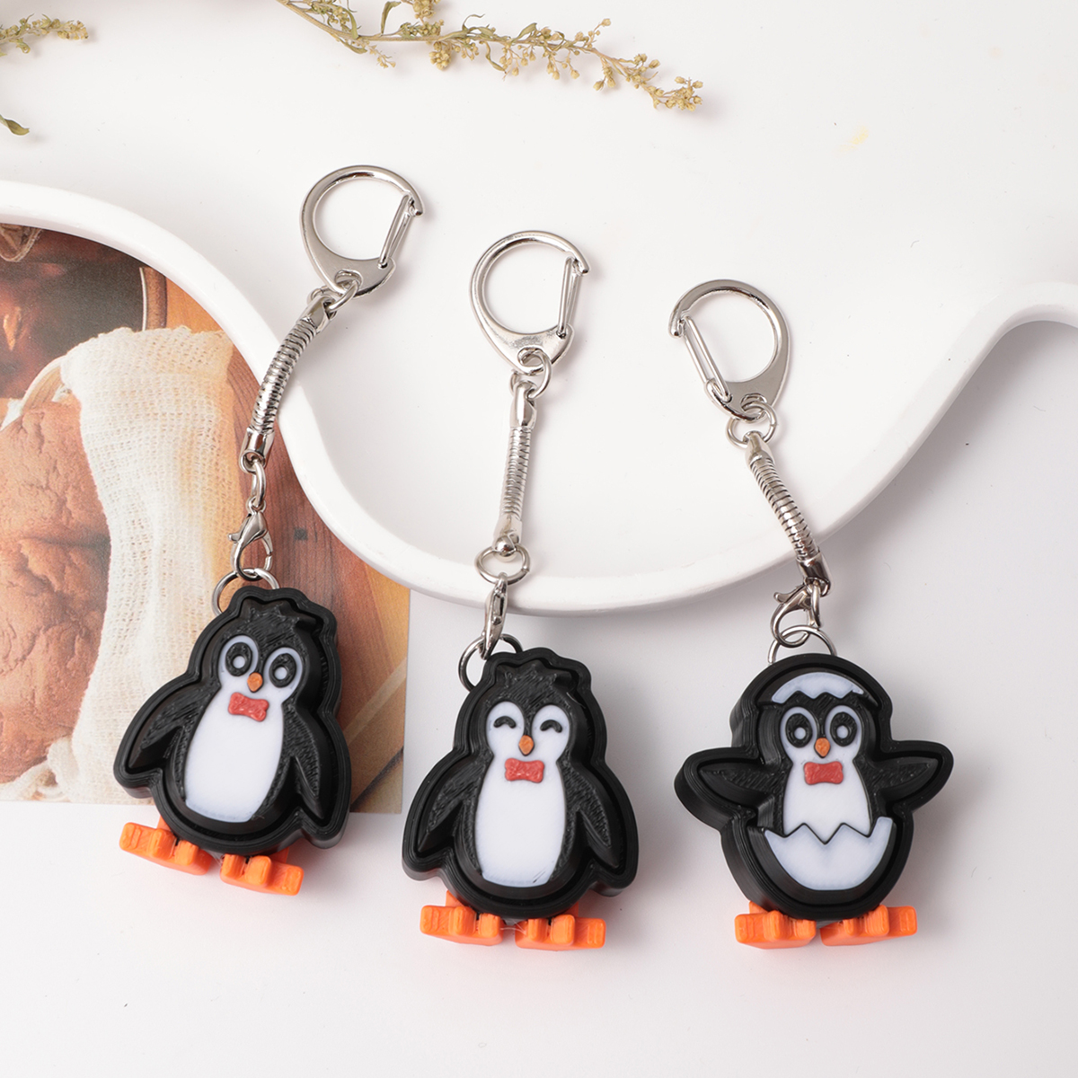 3D printed penguin keychain - an adult stress relief toy with a portable anxiety-reducing gadget featuring a clickable keyboard design