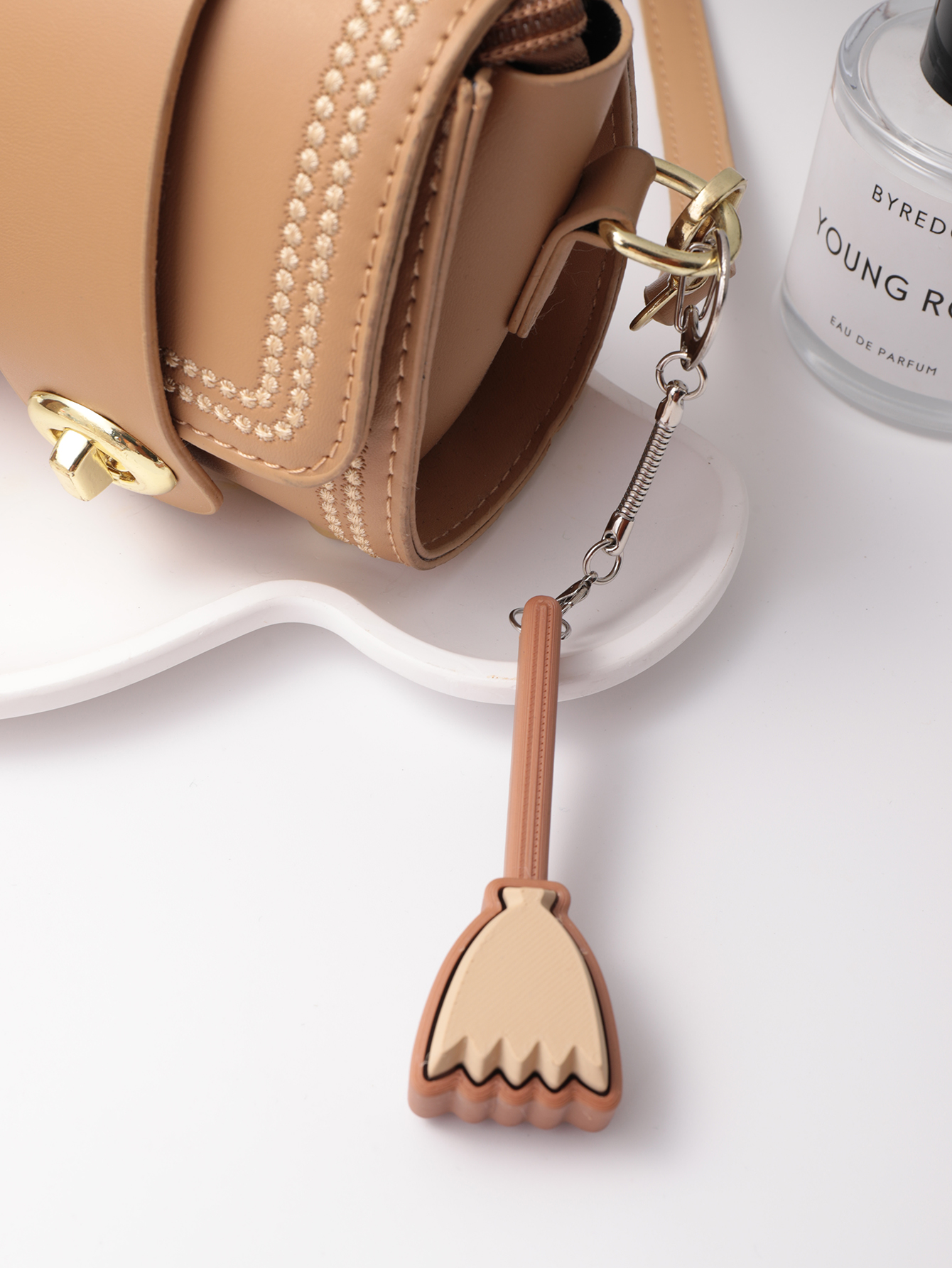 3D printed broom-shaped keychain - an adult stress relief toy with a portable anxiety relief gadget featuring a clickable keyboard design