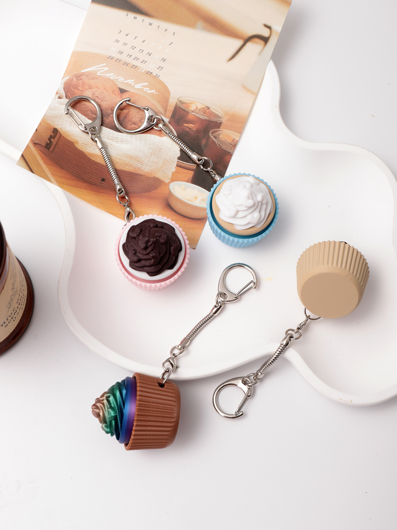 3D printed cupcake-shaped keychain - an adult stress relief toy with a portable anxiety-reducing gadget featuring a clickable keyboard design